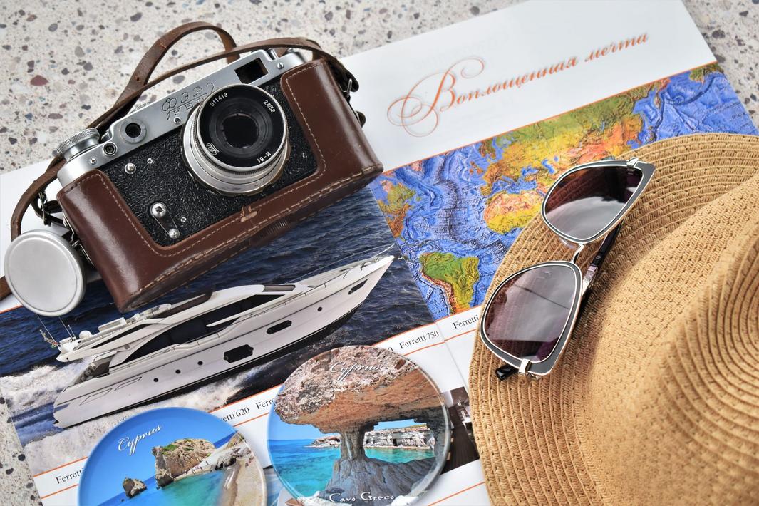 Printed travel brochures for luxury travel products neatly arranged in a boutique travel agent office